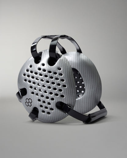 RUDIS Elite Airflow Wrestling Headgear in Silver Carbon, featuring ventilated ear guards with a carbon-fiber pattern, black adjustable straps and RUDIS logo.