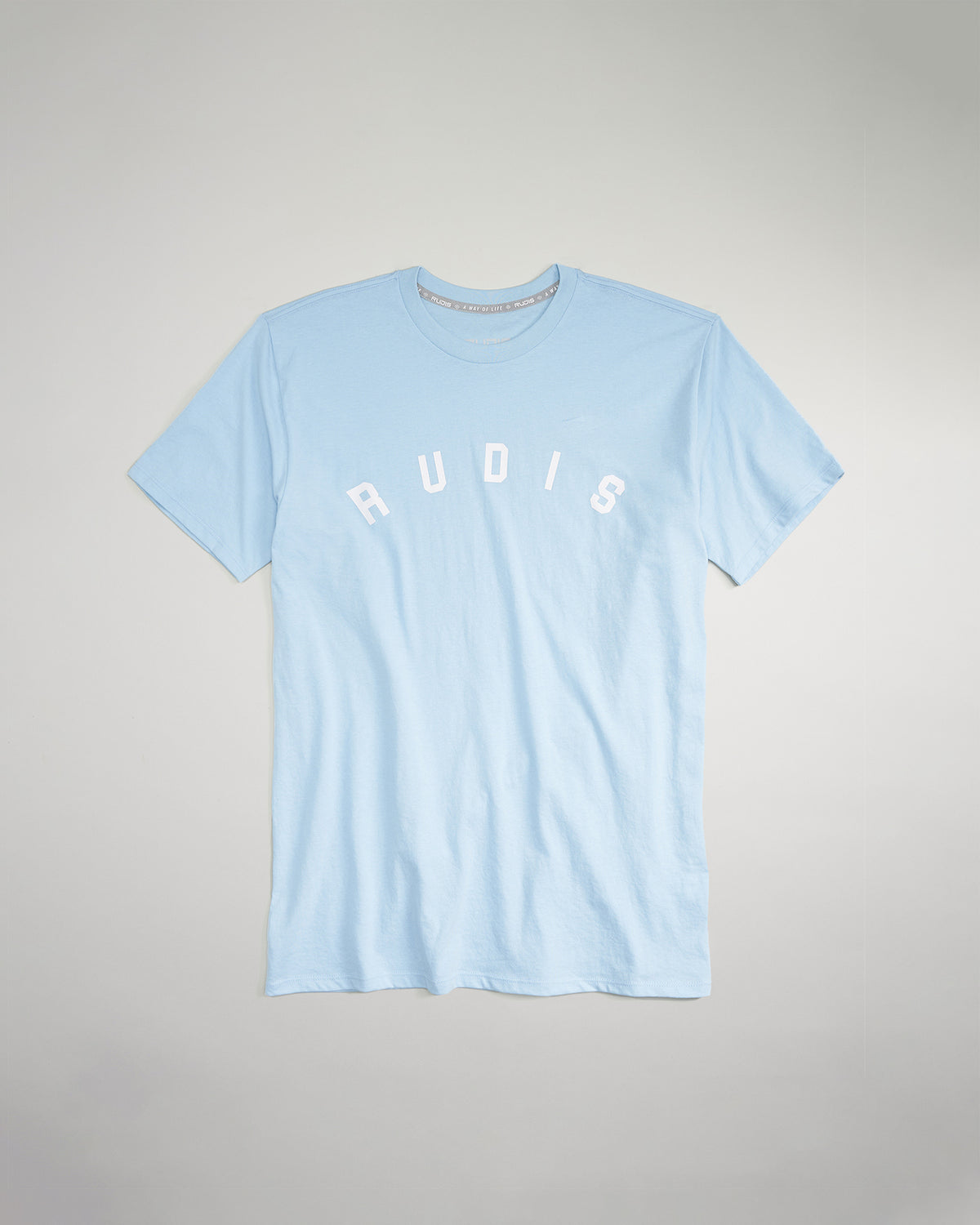 A light blue t-shirt featuring the word RUDIS prominently displayed in white letters across the chest