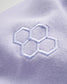 A close-up view of a light lavender fabric featuring a subtle embroidered hexagonal pattern