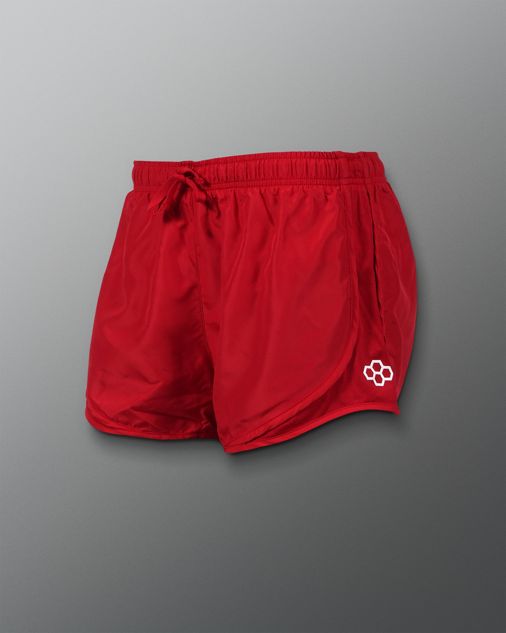 A pair of vibrant red athletic shorts featuring a drawstring waist and a mesh side panel for breathability