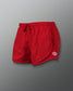 A pair of vibrant red athletic shorts featuring a drawstring waist and a mesh side panel for breathability