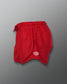 Bright red athletic shorts featuring a comfortable elastic waistband and a mesh fabric design for breathability