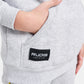 A close-up view of a childs gray sweatshirt featuring a pocket and a RUDIS label