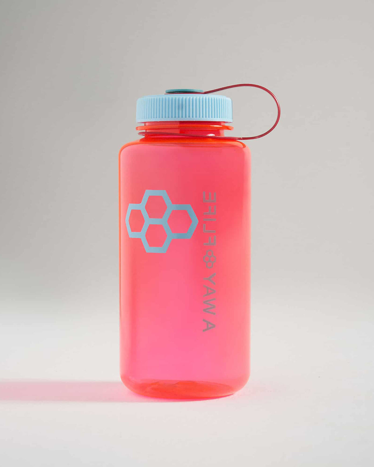 Vibrant pink water bottle with a light blue lid and honeycomb logo perfect for hydration on the go
