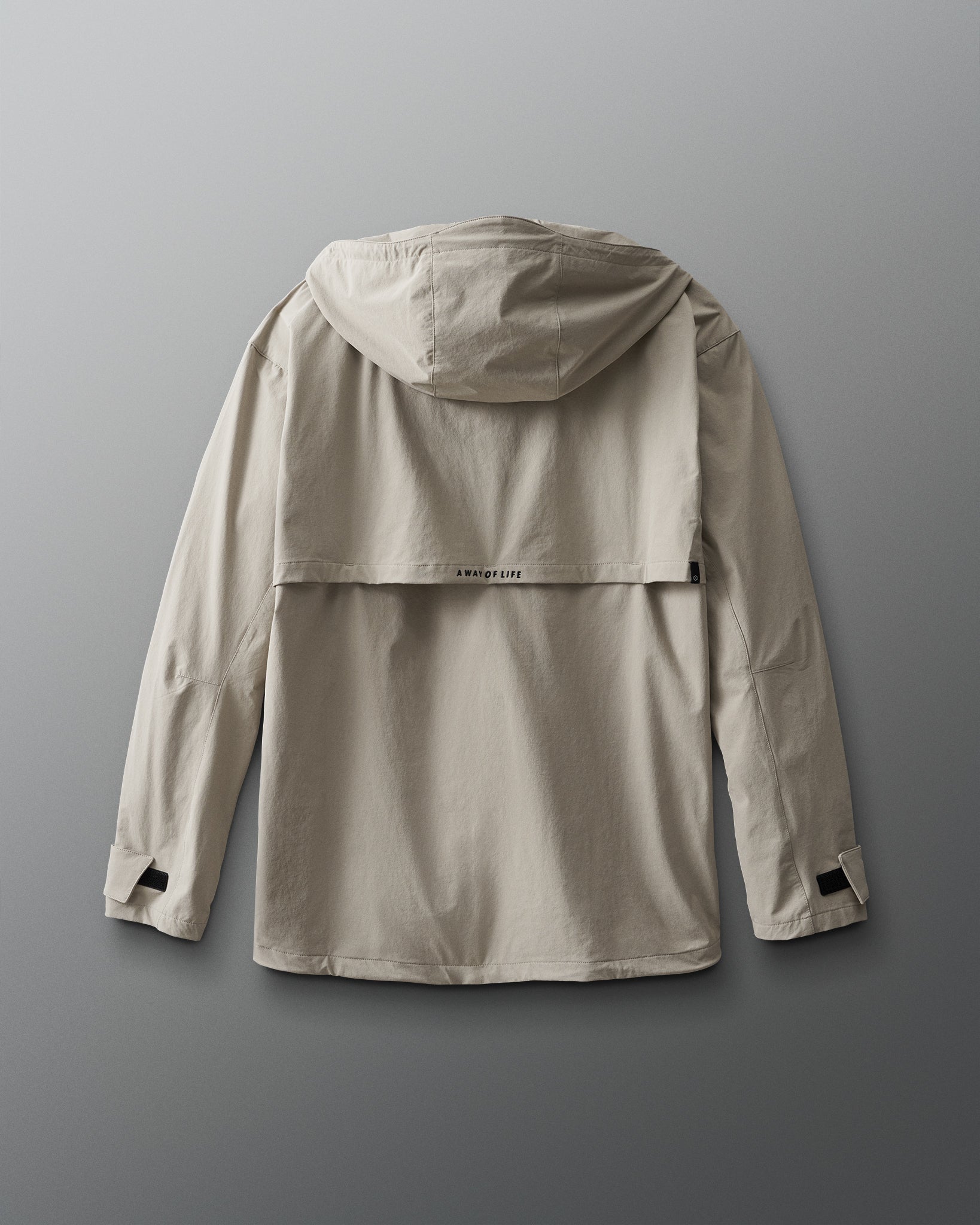 A beige windbreaker jacket back side view with a hood, designed for adults. 