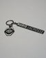 RUDIS Lacrosse metal keychain in black and silver featuring the signature RUDIS hex logo, engraved RUDIS Lacrosse branding, durable metal construction, and split key ring.