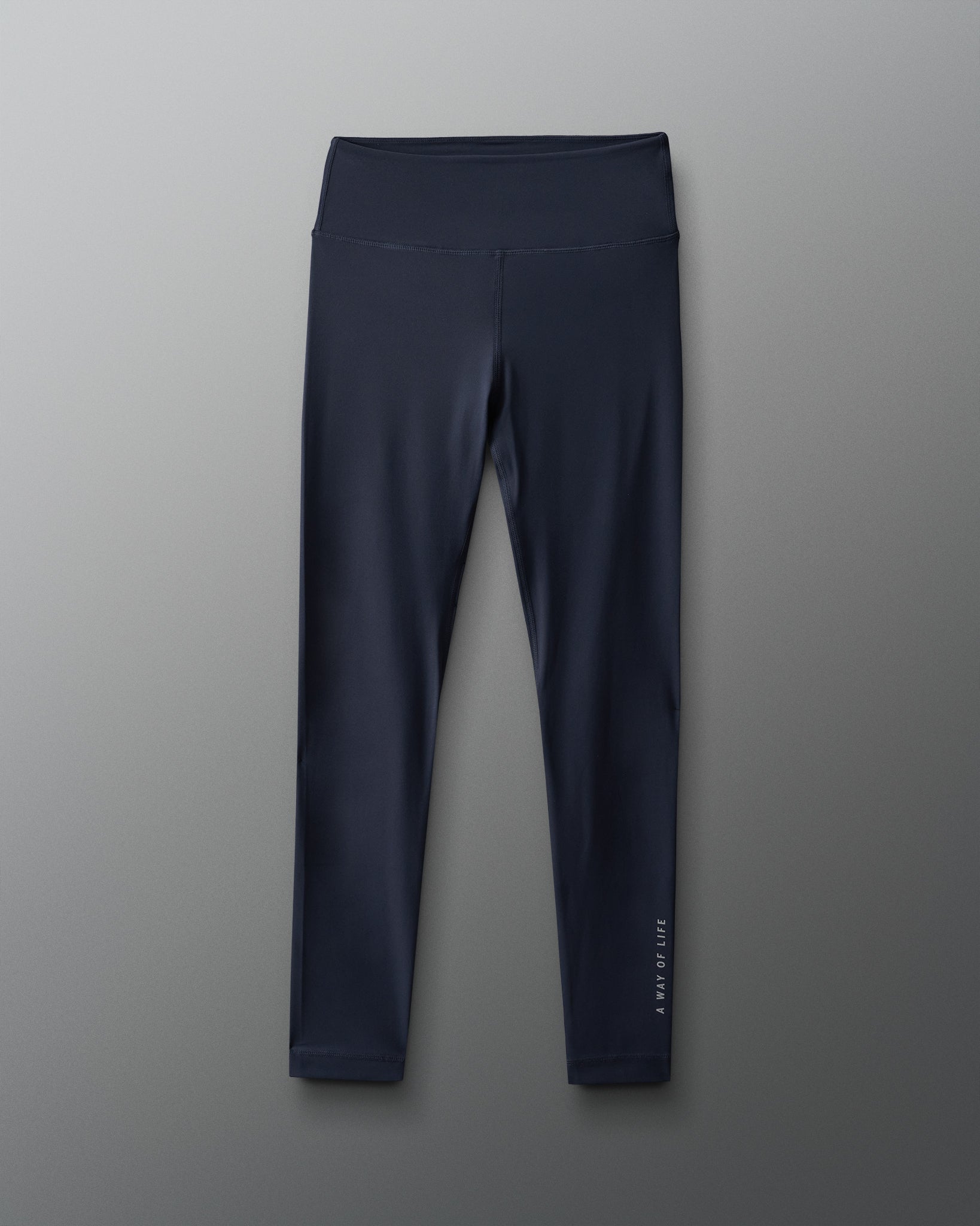 These dark high-waisted leggings with a smooth finish and a logo on the side are designed for both fitness and casual wear.