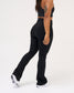 Back view of a model wearing black RUDIS Flare Leggings, showcasing the high-rise waistband, contoured fit, and flared-leg silhouette.