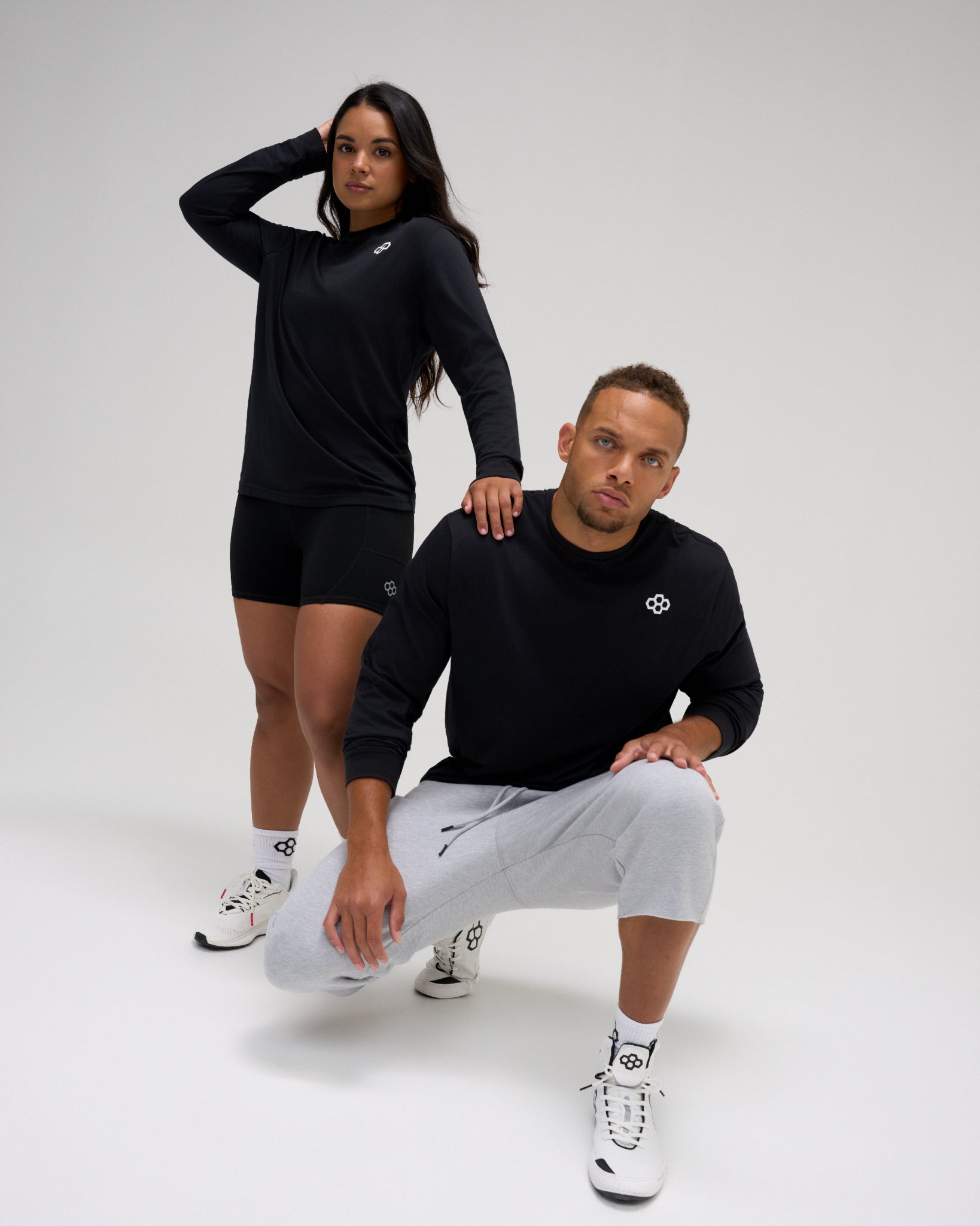 RUDIS Essential Hex Elite Super Soft Long Sleeve T-Shirt in black worn by male and female athletes with RUDIS Hex chest logo.