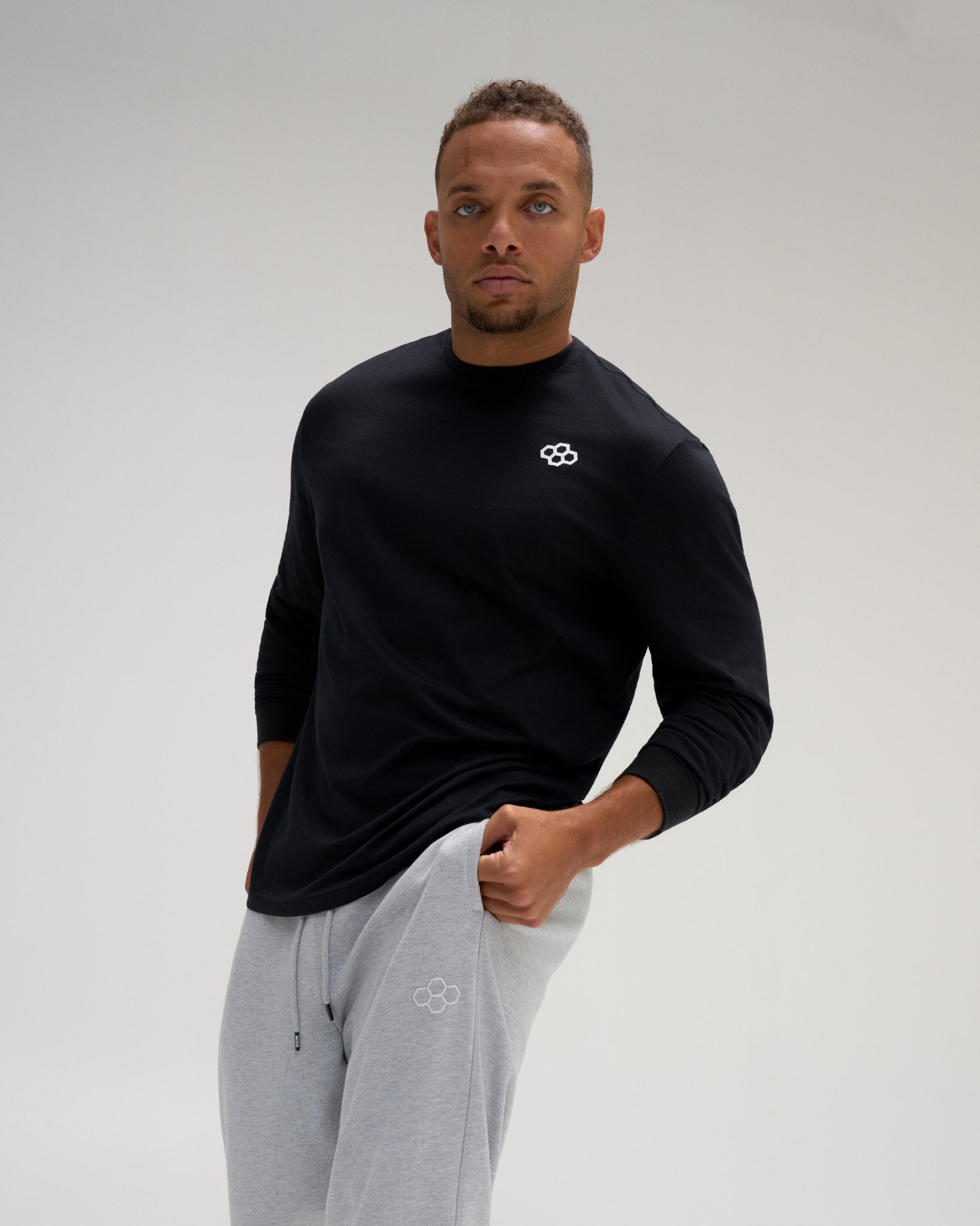 Male athlete wearing the black RUDIS Essential Hex Elite Super Soft Long Sleeve T-Shirt with white Hex chest logo.