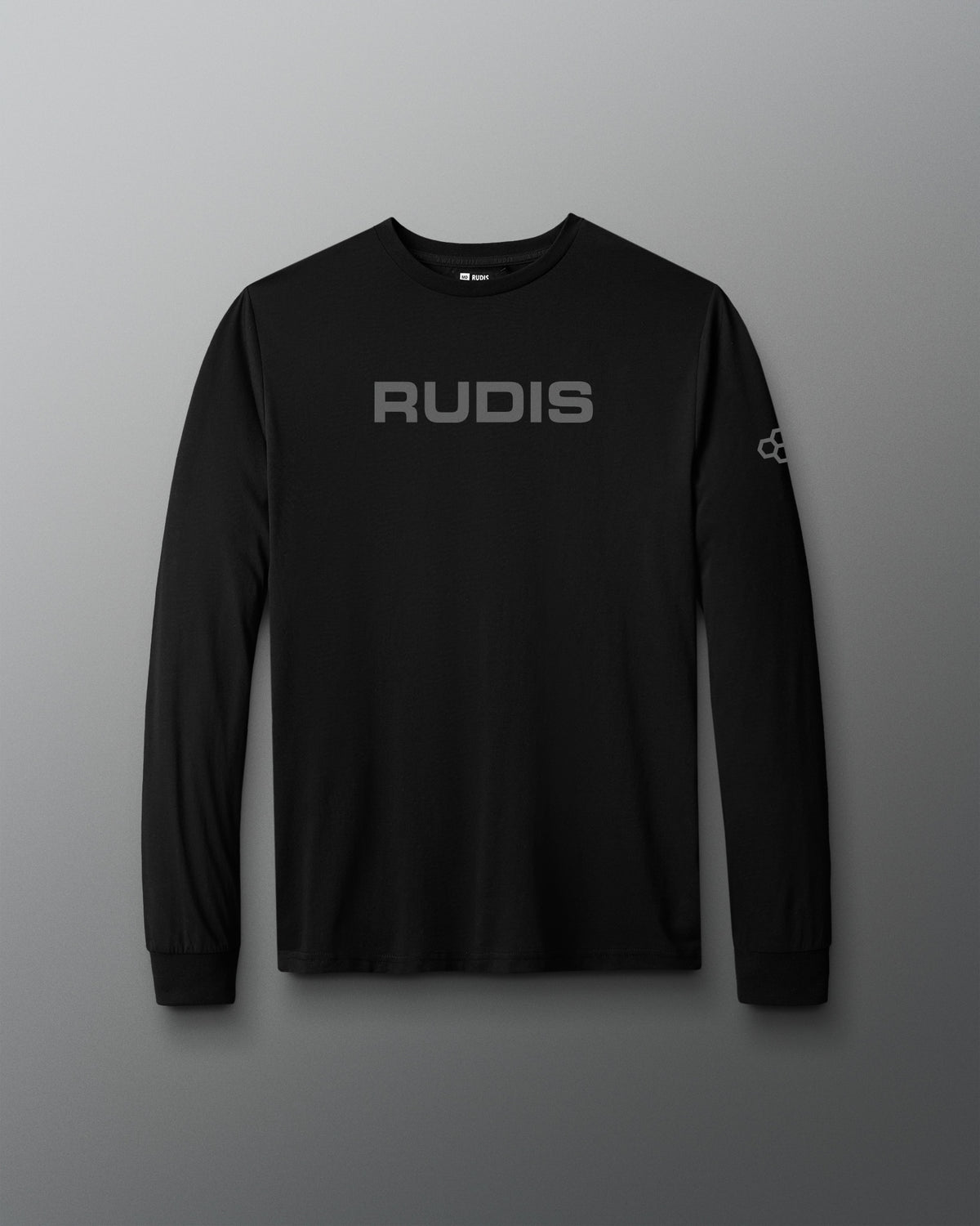 A black long-sleeve performance shirt with 'RUDIS' printed in gray across the chest and a small logo on the right sleeve, displayed against a dark gray gradient background.