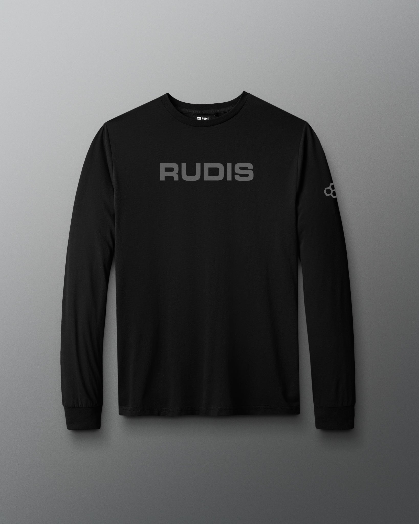 A black long-sleeve performance shirt with 'RUDIS' printed in gray across the chest and a small logo on the right sleeve, displayed against a dark gray gradient background.