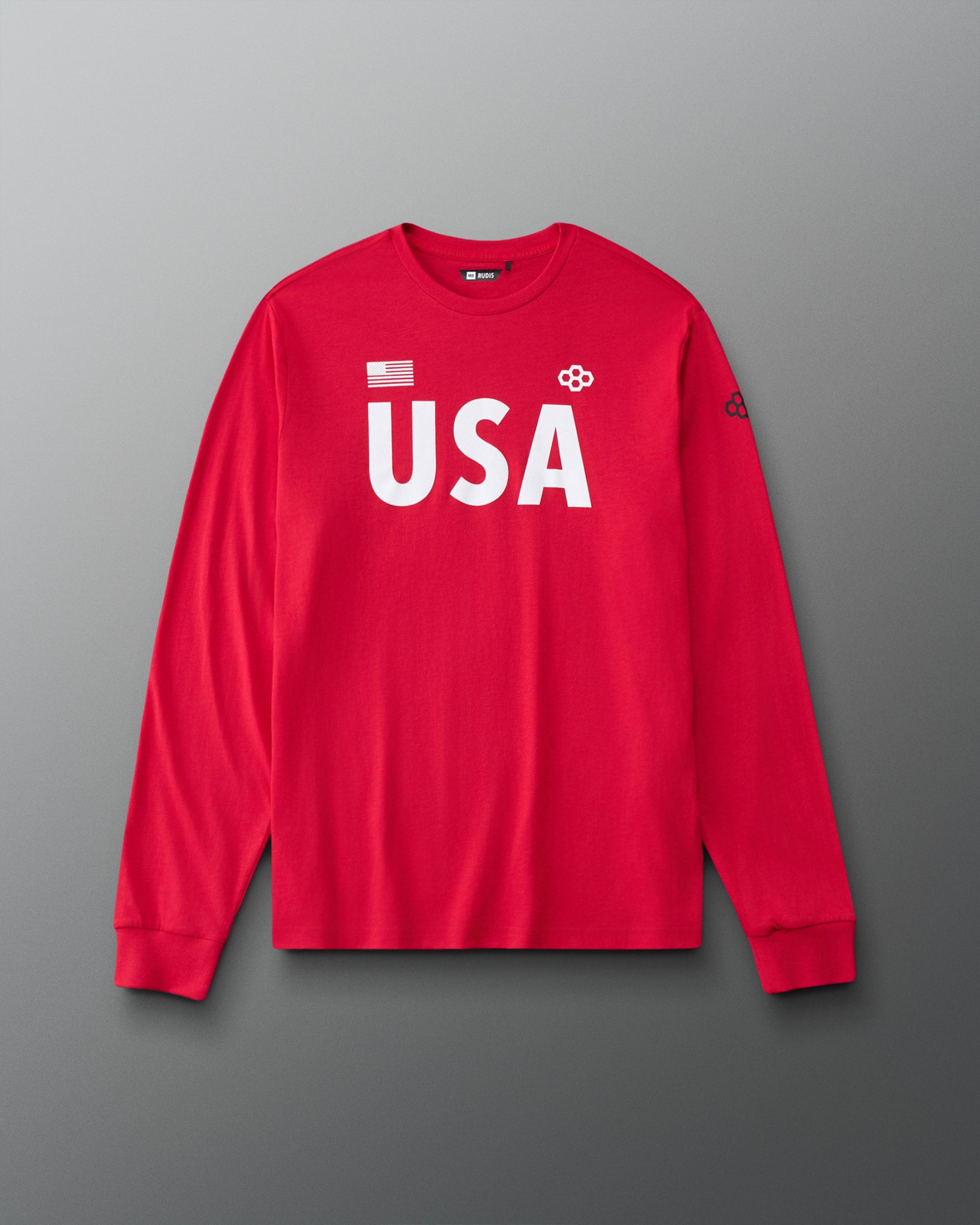 Front view of RUDIS USA Elite Super Soft Long Sleeve Shirt in red, featuring bold white USA lettering, an American flag graphic, RUDIS Hex logos, a crewneck collar, and ribbed cuffs.