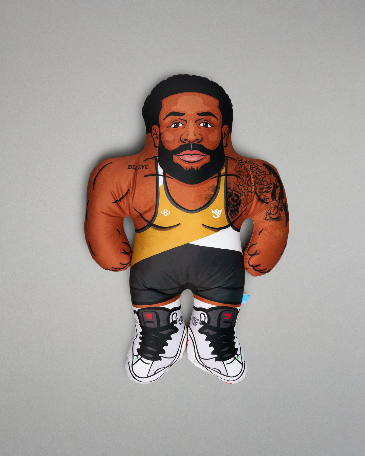 Pillow of a man with tattoos and a wrestling singlet on a gray background