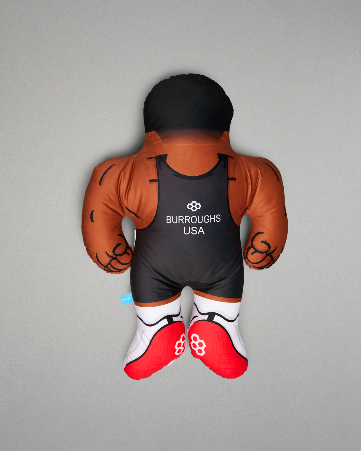 PIllow resembling a wrestler with 'Burroughs USA' branding on a gray background