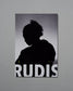 Silhouette of a person against a gray background with 'RUDIS' branding.