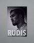 Poster of a shirtless man with 'RUDIS' text on a gray background