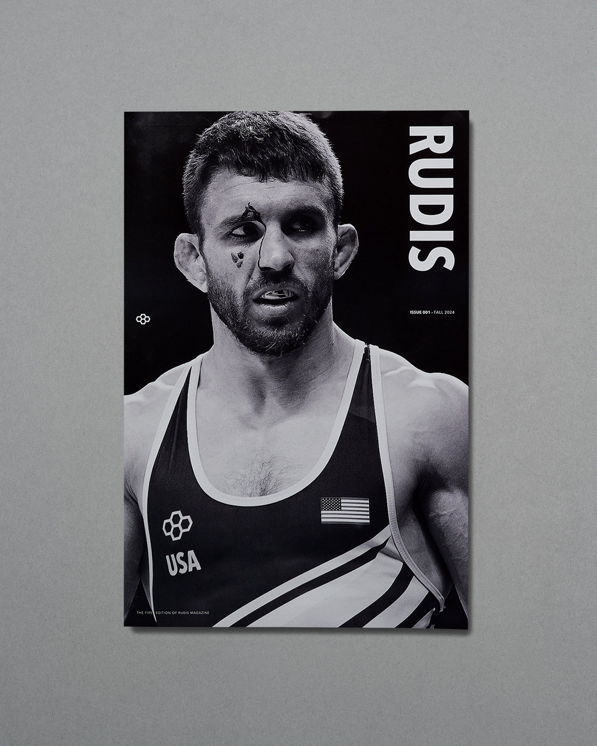 Black and white poster of a wrestler with 'RUDIS' branding on a gray background
