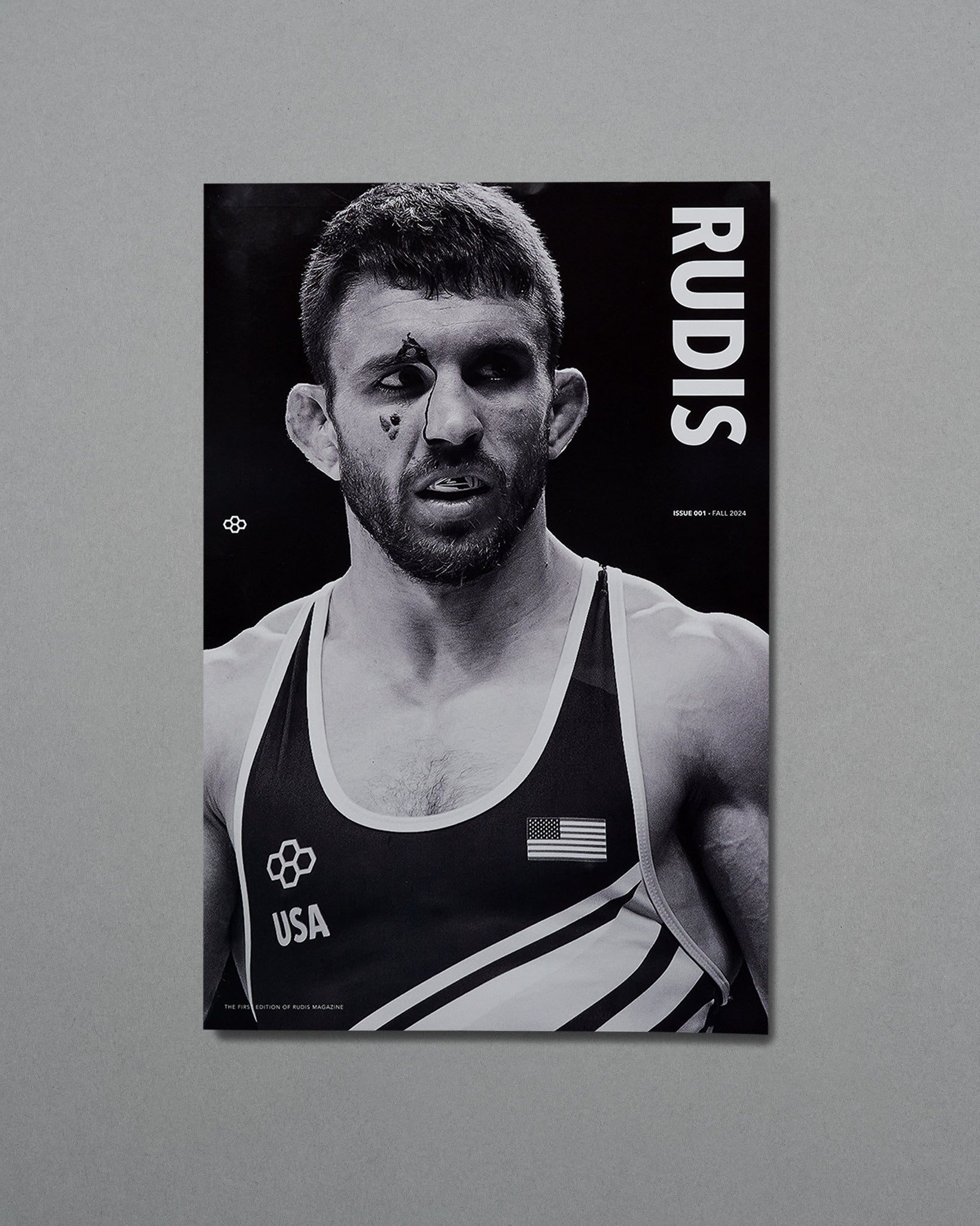 Black and white poster of a wrestler with 'RUDIS' branding on a gray background