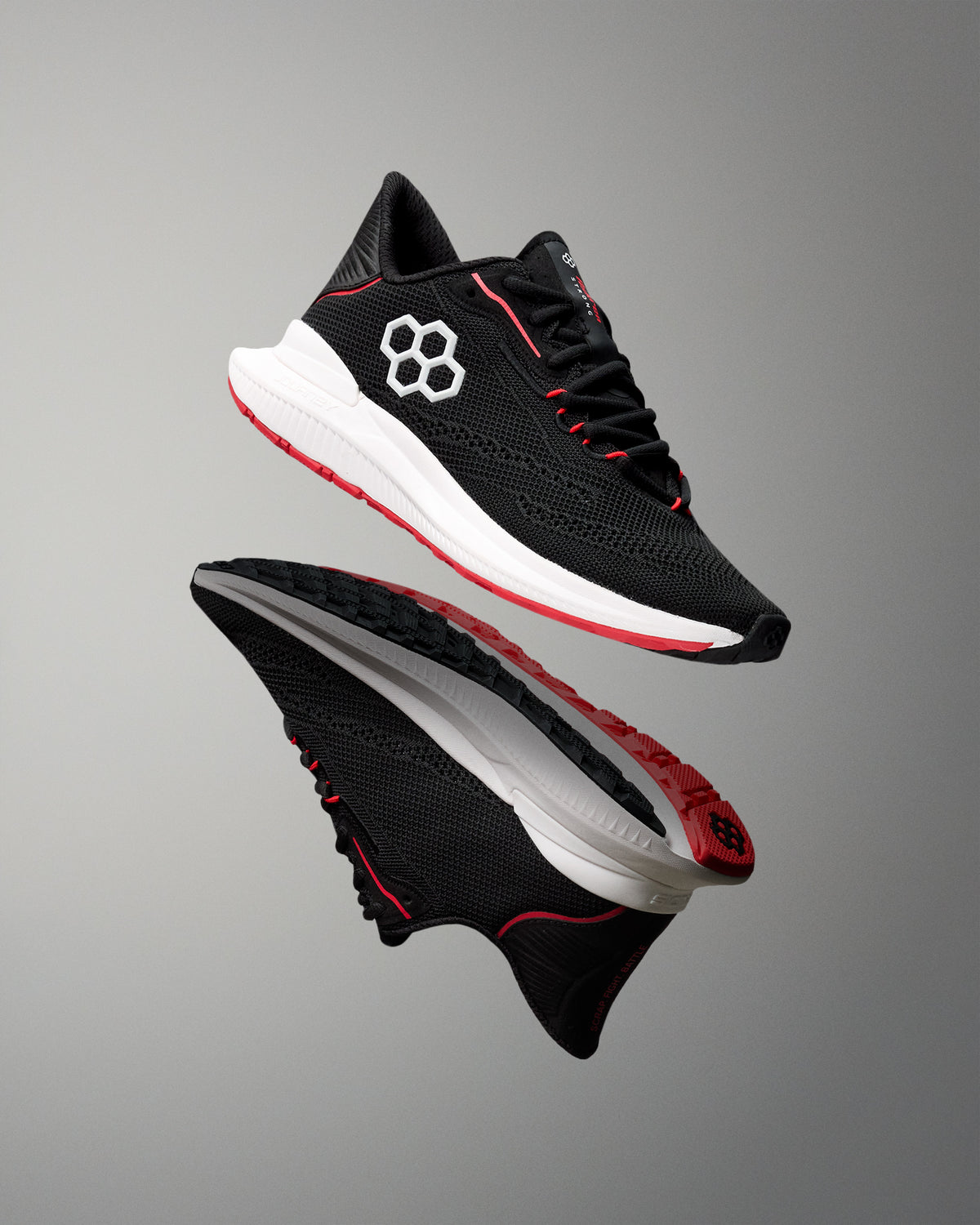 Black and red athletic shoe with a brand logo on a gray background