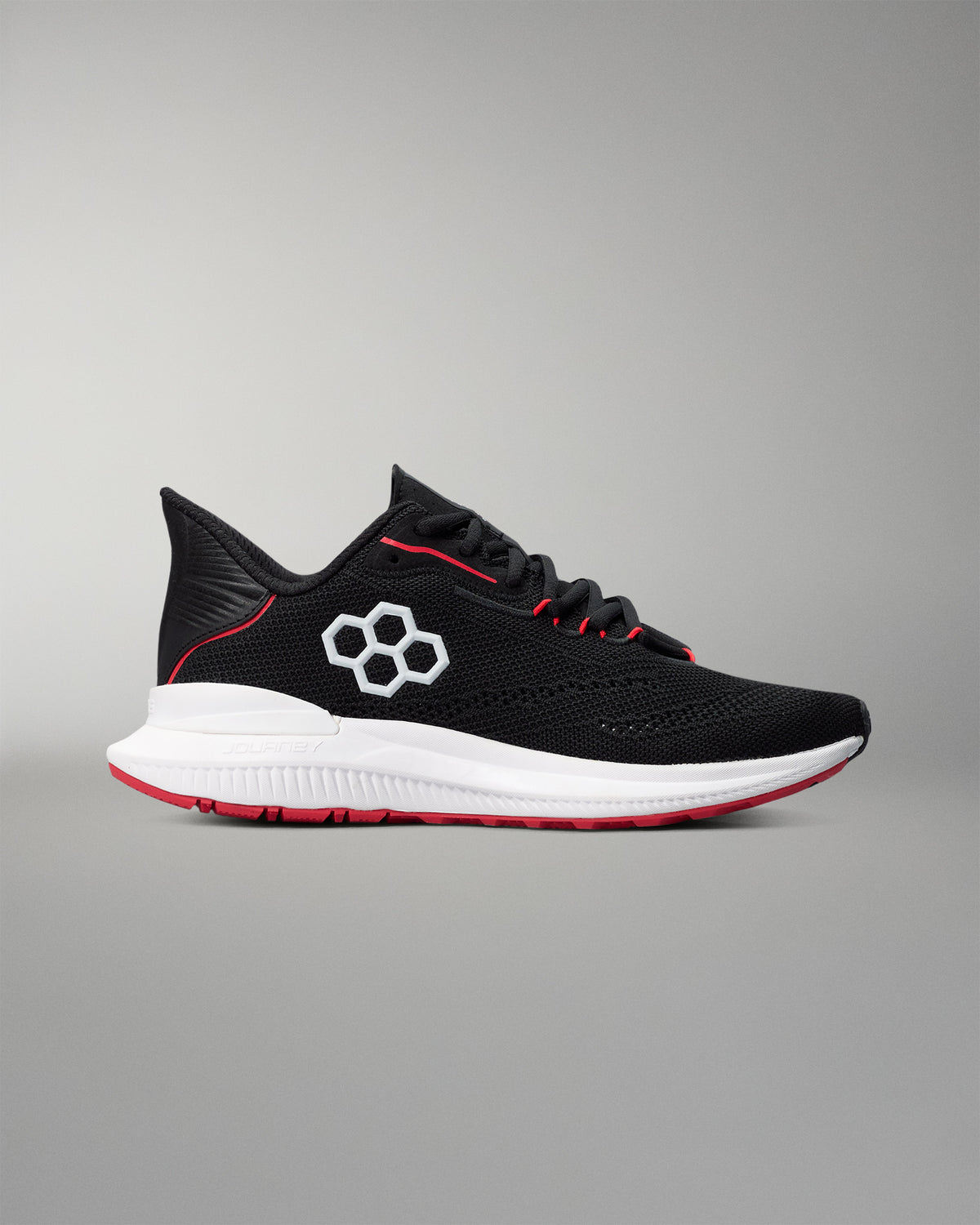 Black running shoe with red accents on a gray background