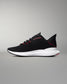 Black running shoe with white sole on a gray background