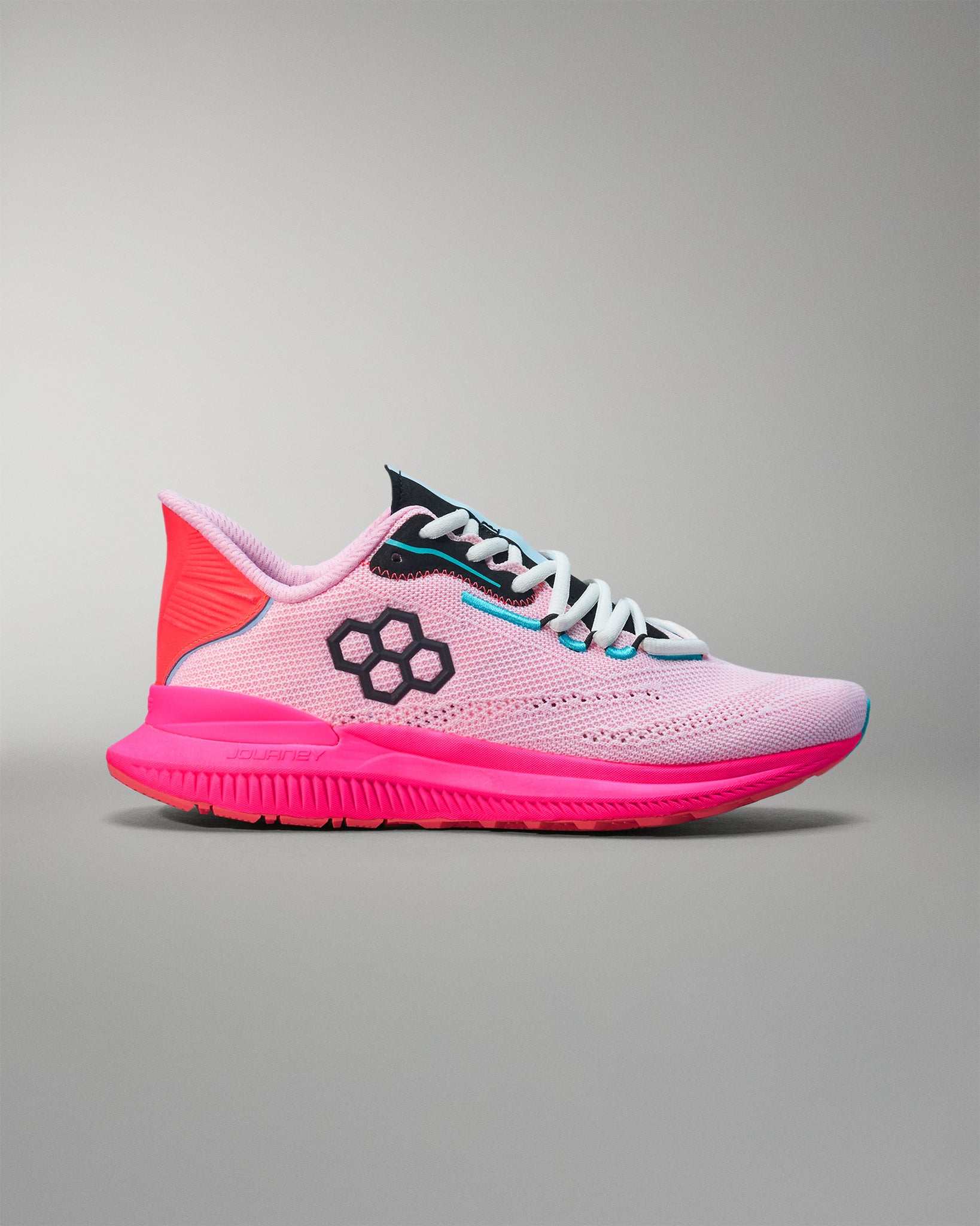 Pink and black running shoe on a gray background