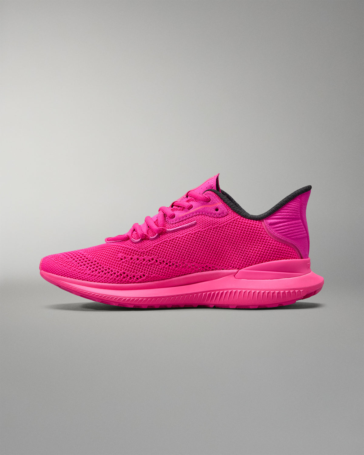 Pink athletic shoe on a gray background