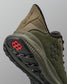 Green training shoe with black sole and red logo on a gray background