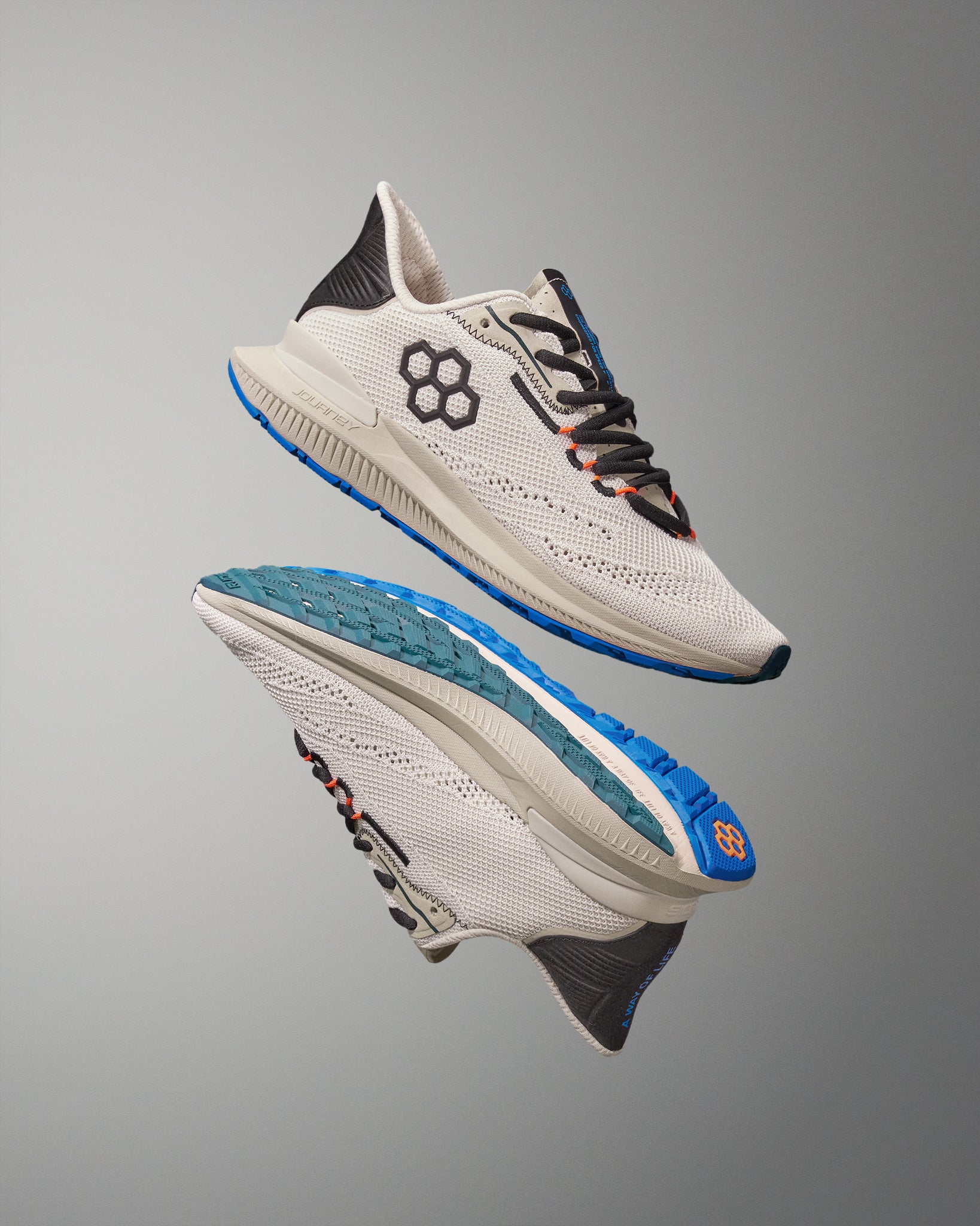 White running shoes with blue soles on a gray background