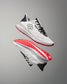 White running shoes with red soles on a gray background