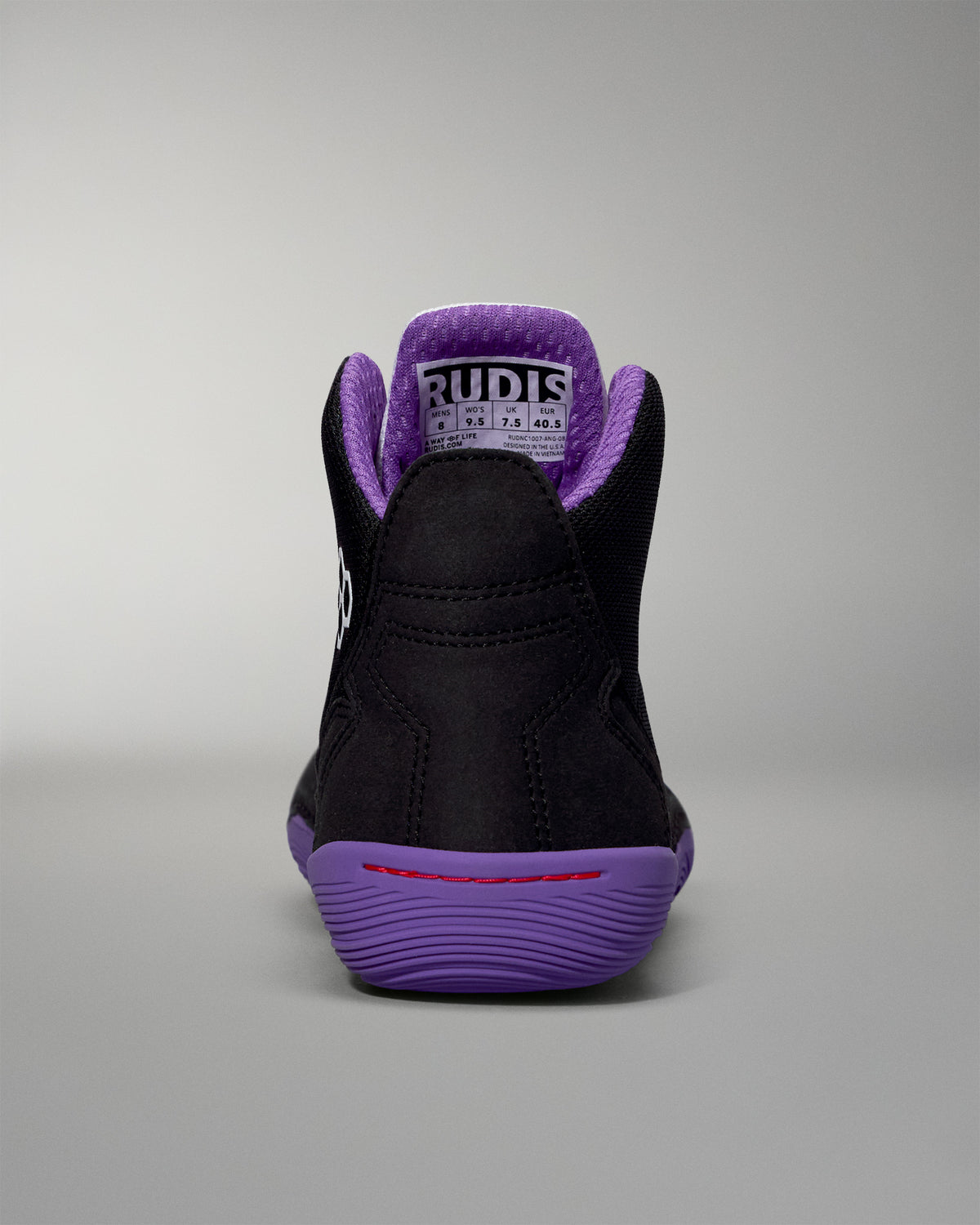 Black high-top sneaker with purple accents on a gray background