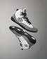 A pair of white and black RUDIS Courage adult wrestling shoes with a micro-suede rand and a stable outsole.