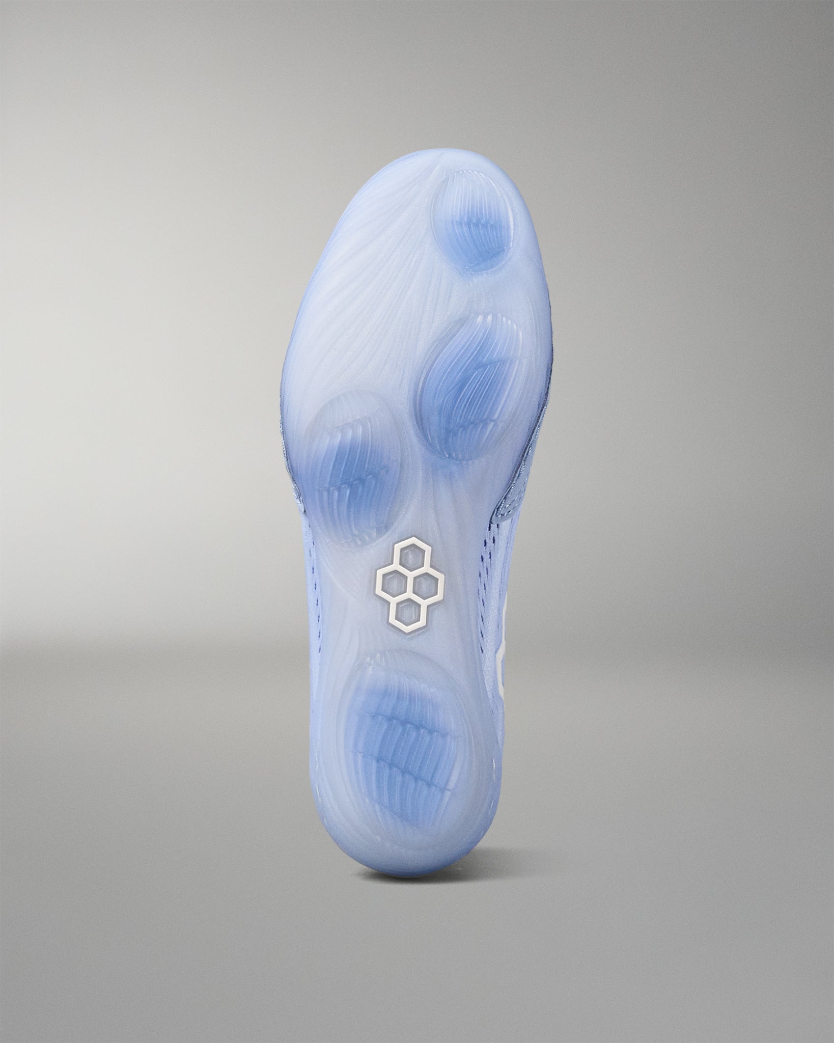 Blue wrestling shoe sole with a RUDIS brand logo on a gray background