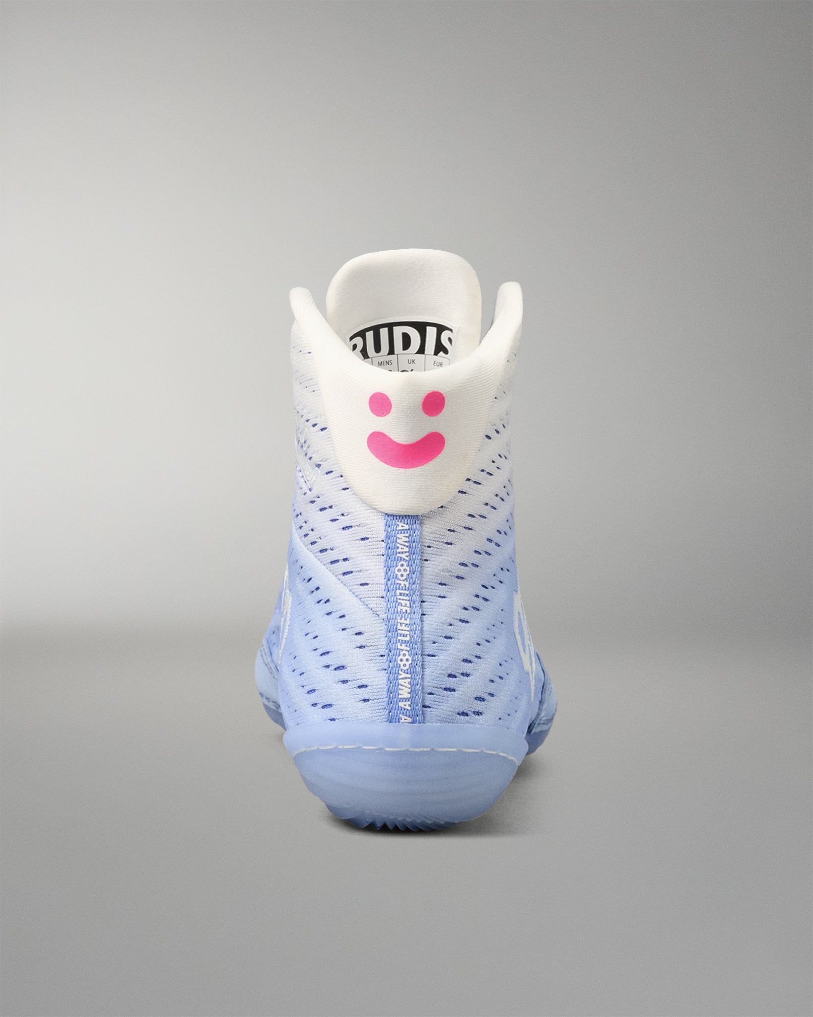 wrestling shoe with a smiley face design on a gray background