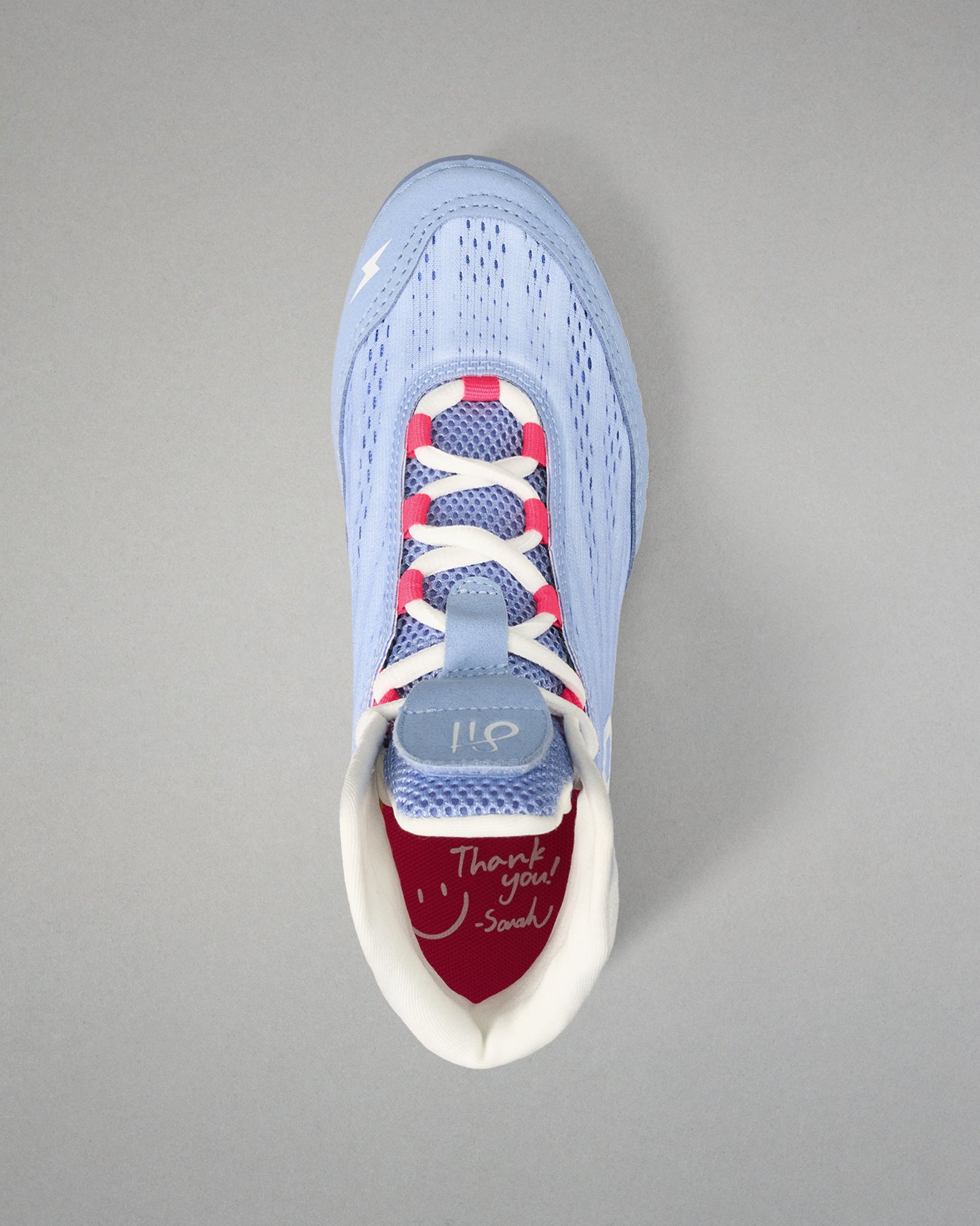 Light blue wrestling shoe with pink interior and 'Thank you' text on a gray background