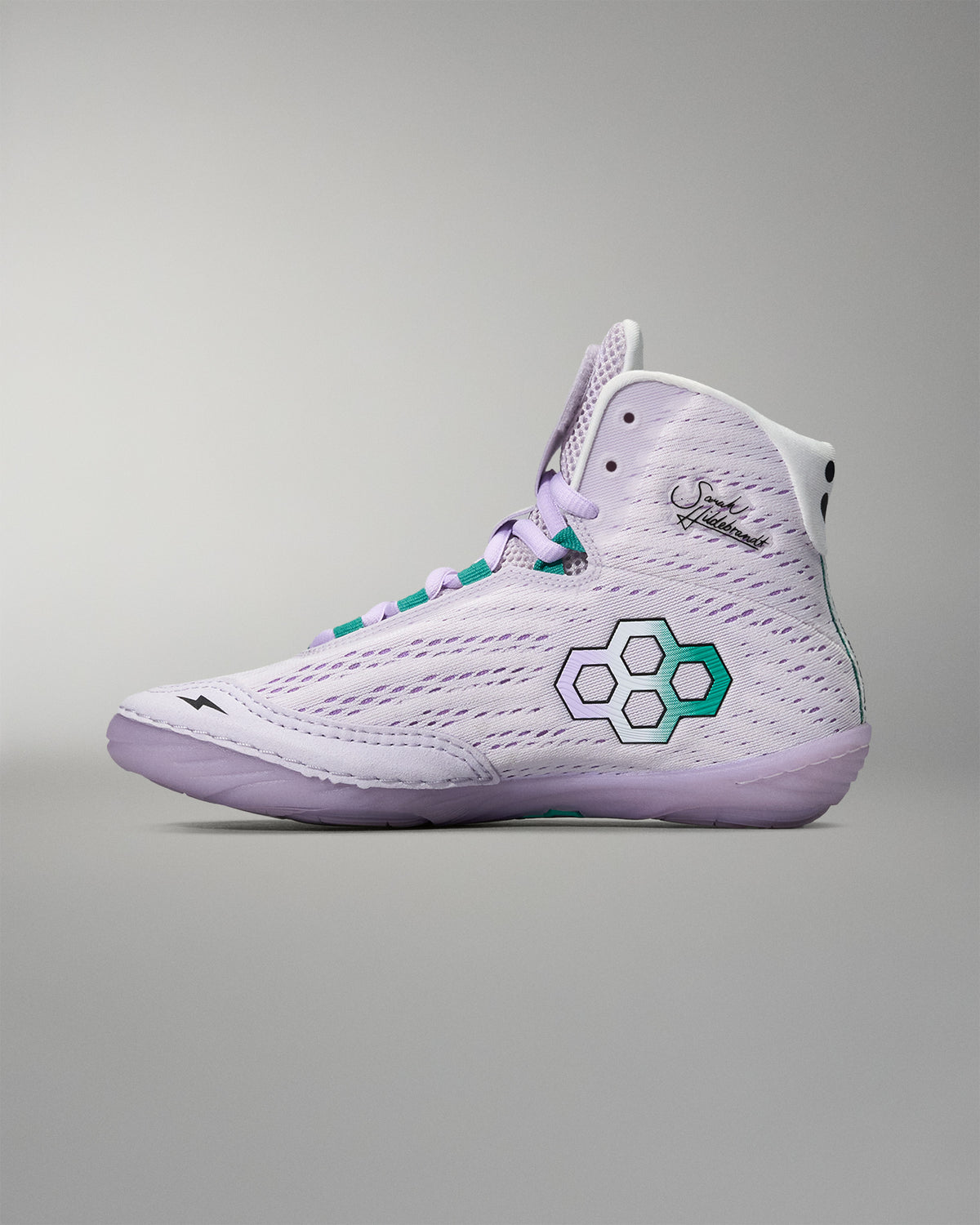 White high-top sneaker with a green logo on a gray background