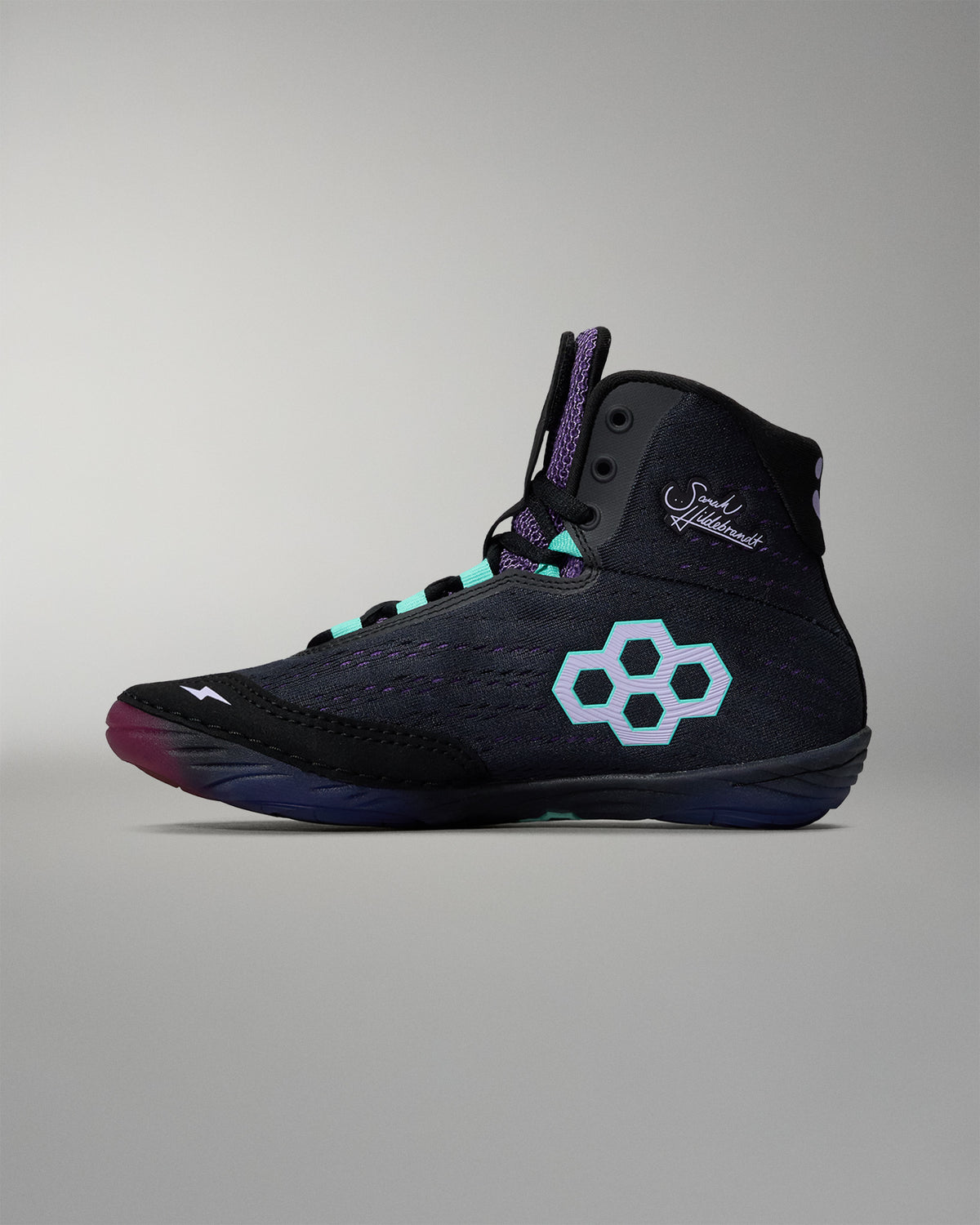 Black high-top sneaker with a unique logo on a gray background