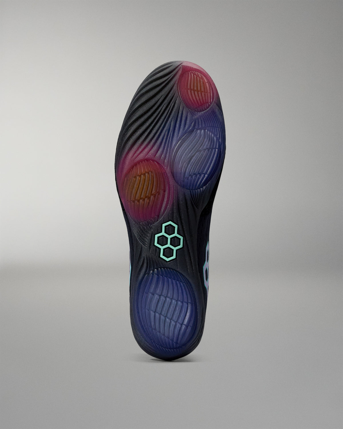 Close-up of a shoe sole with a brand logo on a gray background