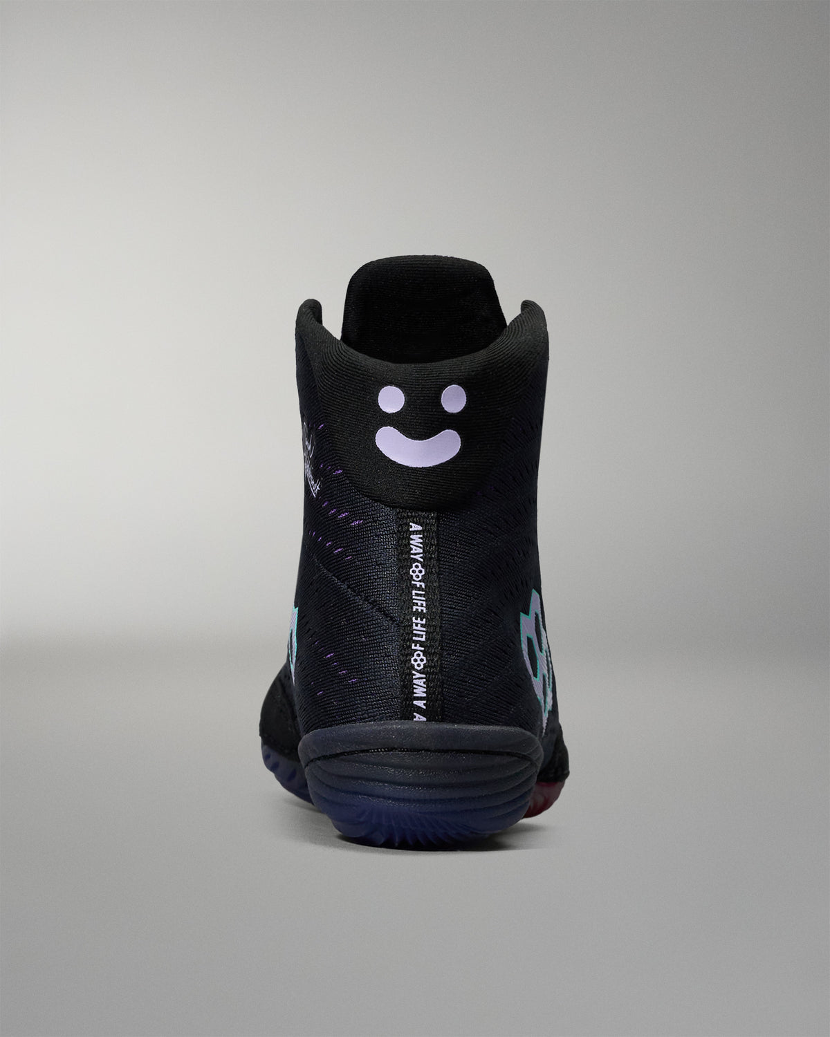 Black sneaker with a smiley face design on a gray background