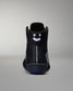 Black sneaker with a smiley face design on a gray background