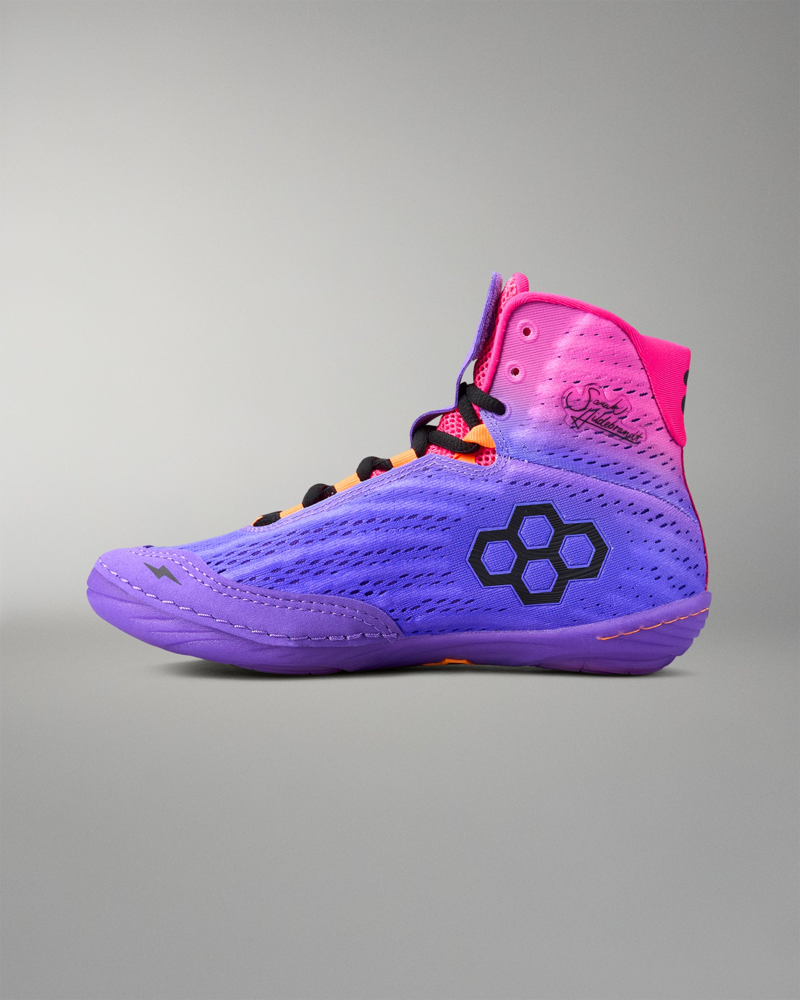 Colorful wrestling shoe with a brand logo on a gray background