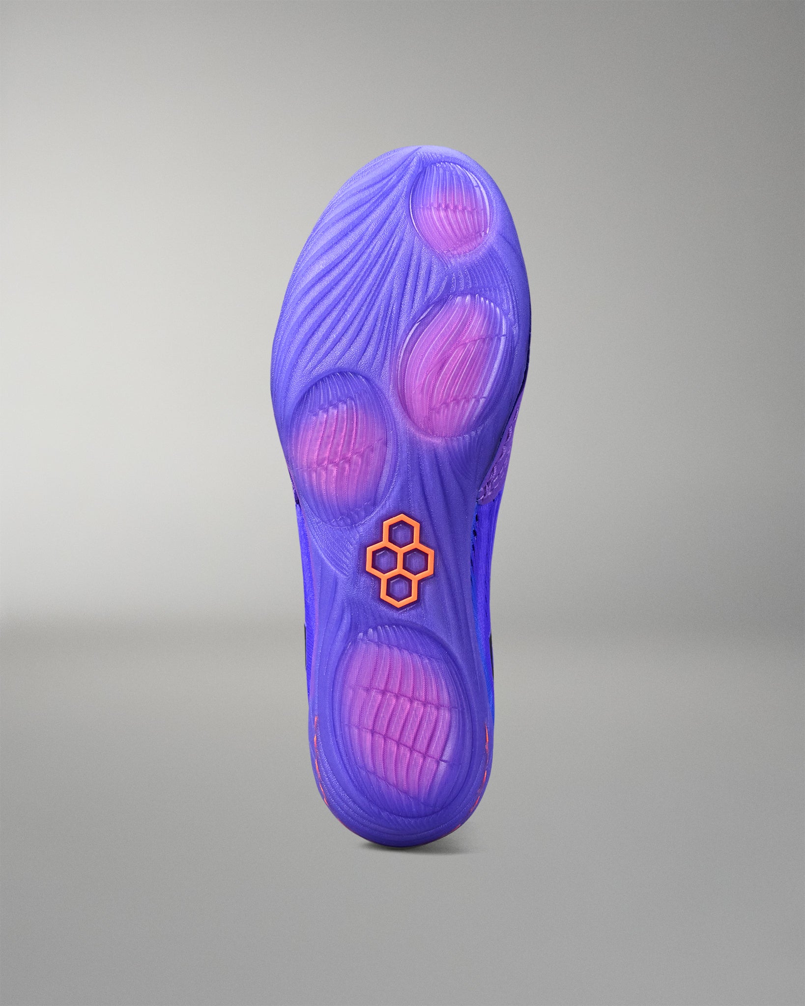 Purple wrestling shoe sole with a brand logo on a gray background