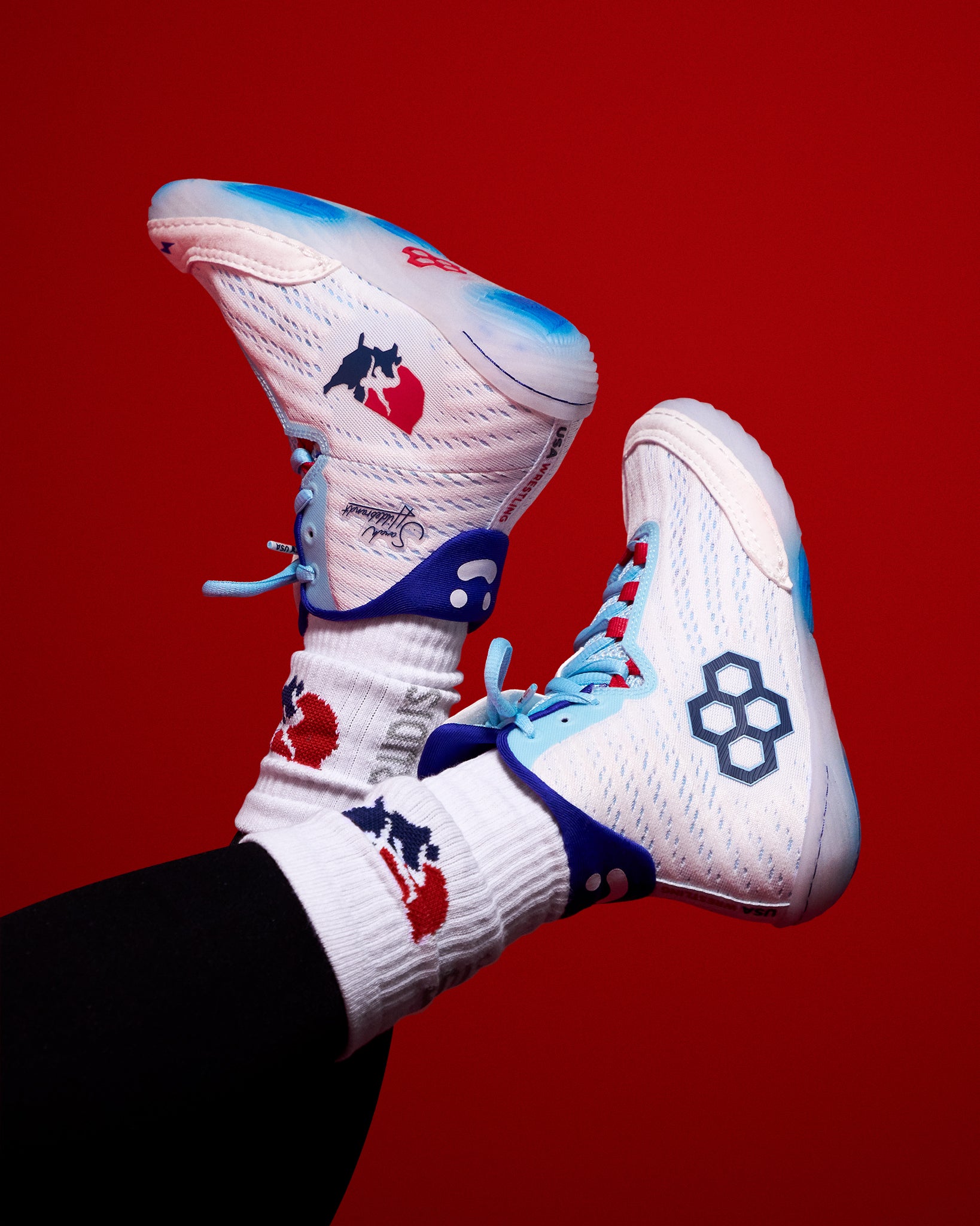 RUDIS Sarah Hildebrandt signature USA Wrestling shoes in white with red and blue accents, featuring the USA Wrestling logo and lightweight high-top design built for elite women’s wrestling performance.