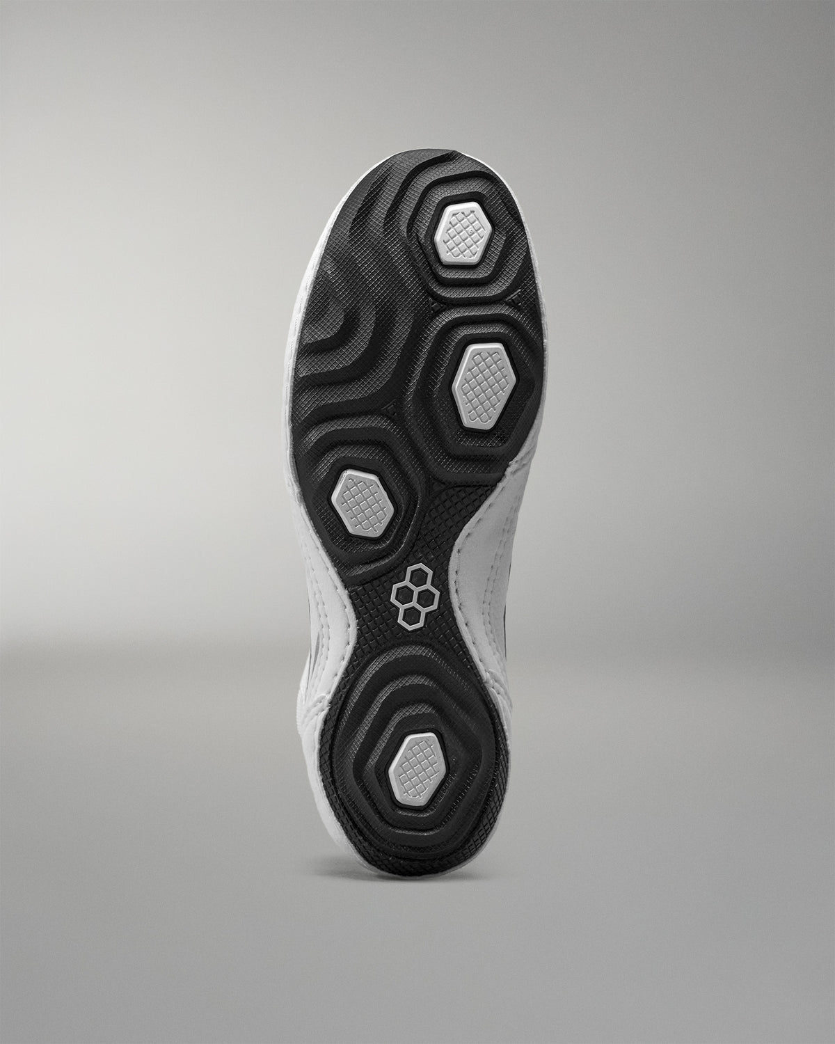 Close-up of a Wrestling shoe sole with a geometric pattern on a gray background