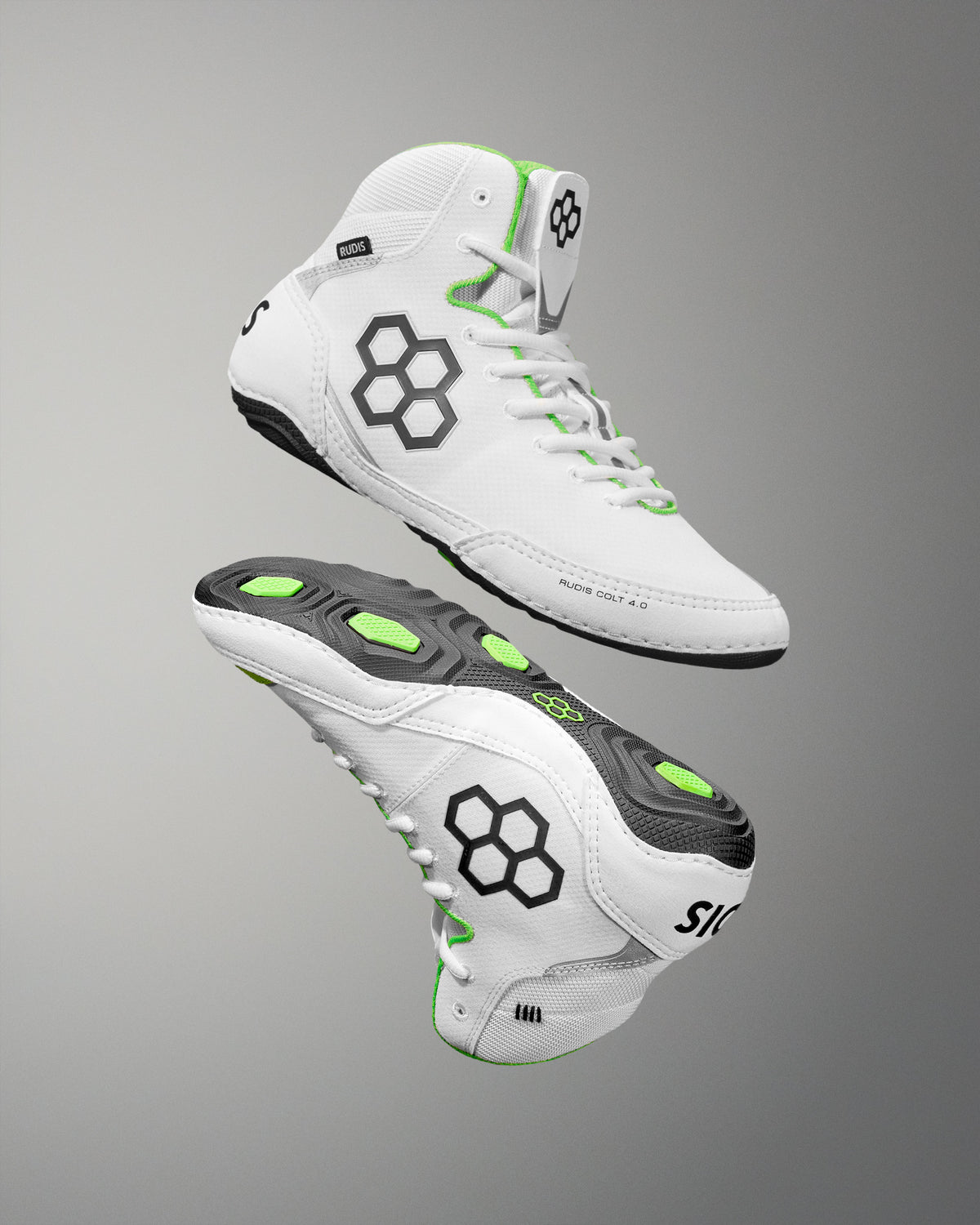 White wrestling shoes with black and green accents on a gray background