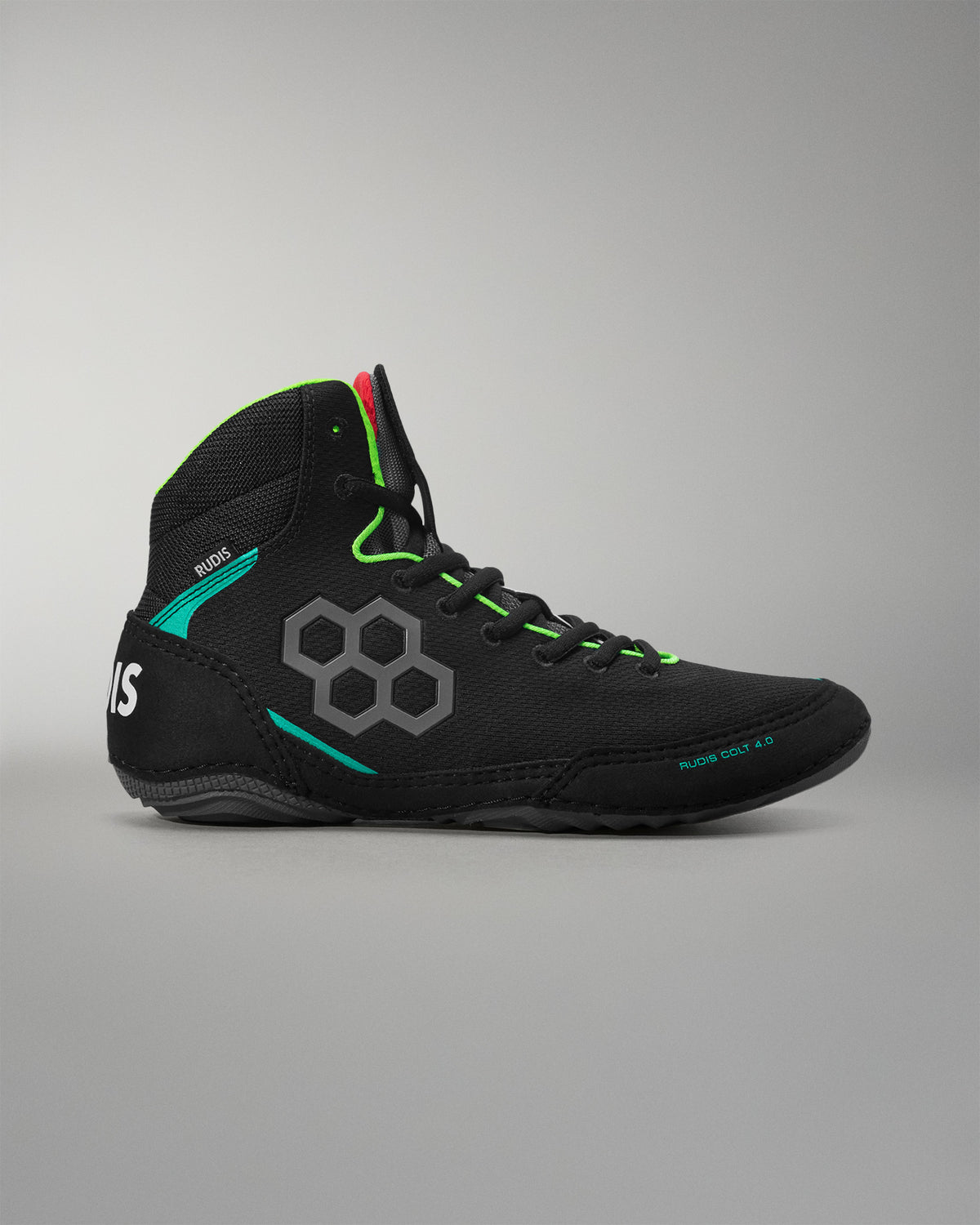 Black wrestling shoe with green accents on a gray background