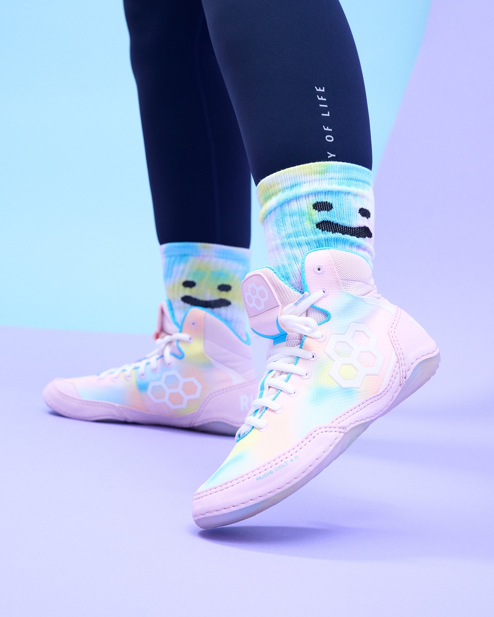 Colorful Wrestling shoes with cartoon face design on a light blue background