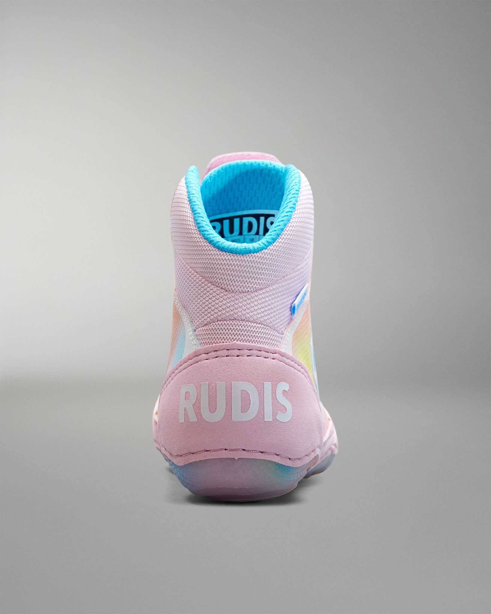 Pink Wrestling shoe with blue lining on a gray background