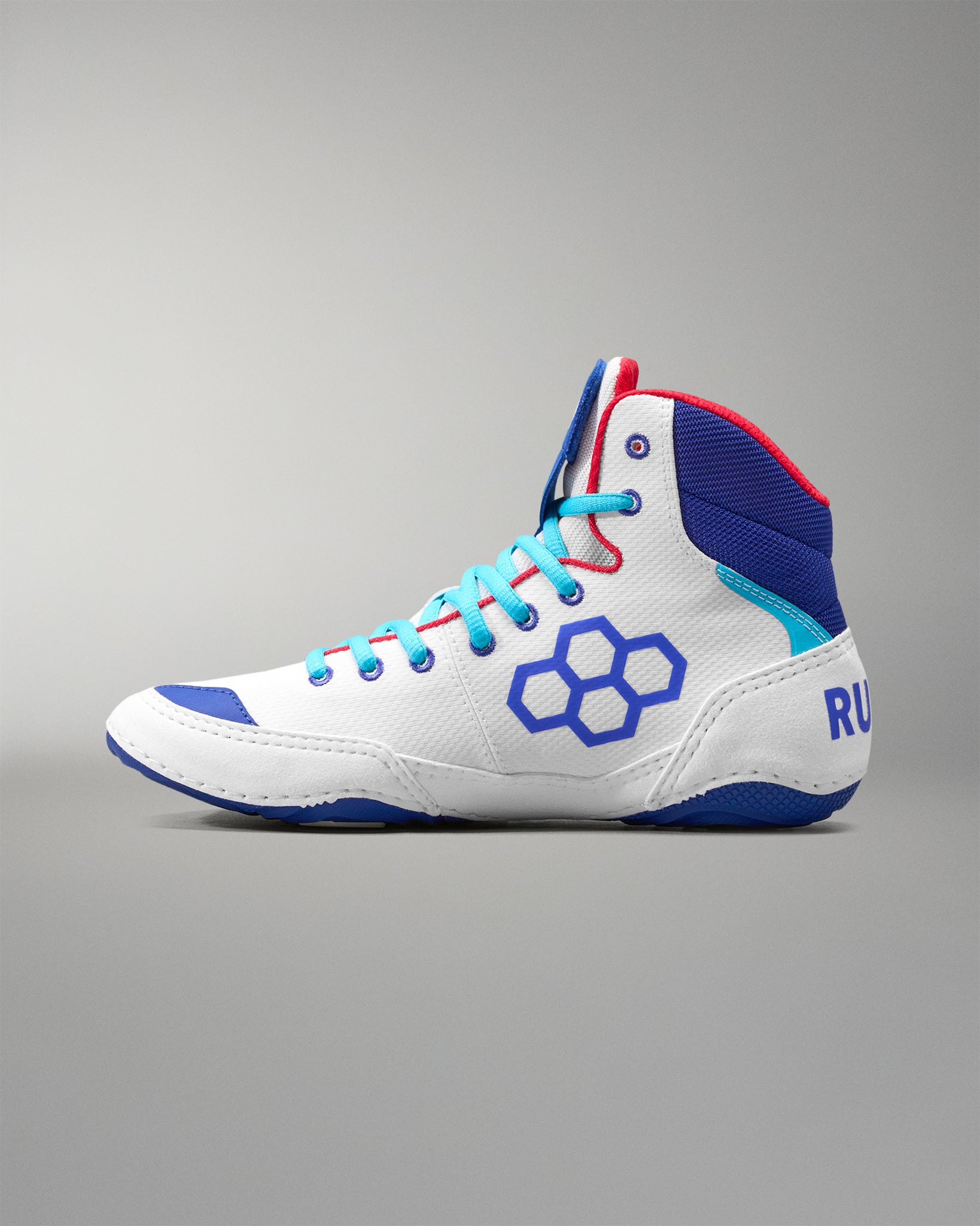 White USA Wrestling Shoes with blue and red accents on a gray background